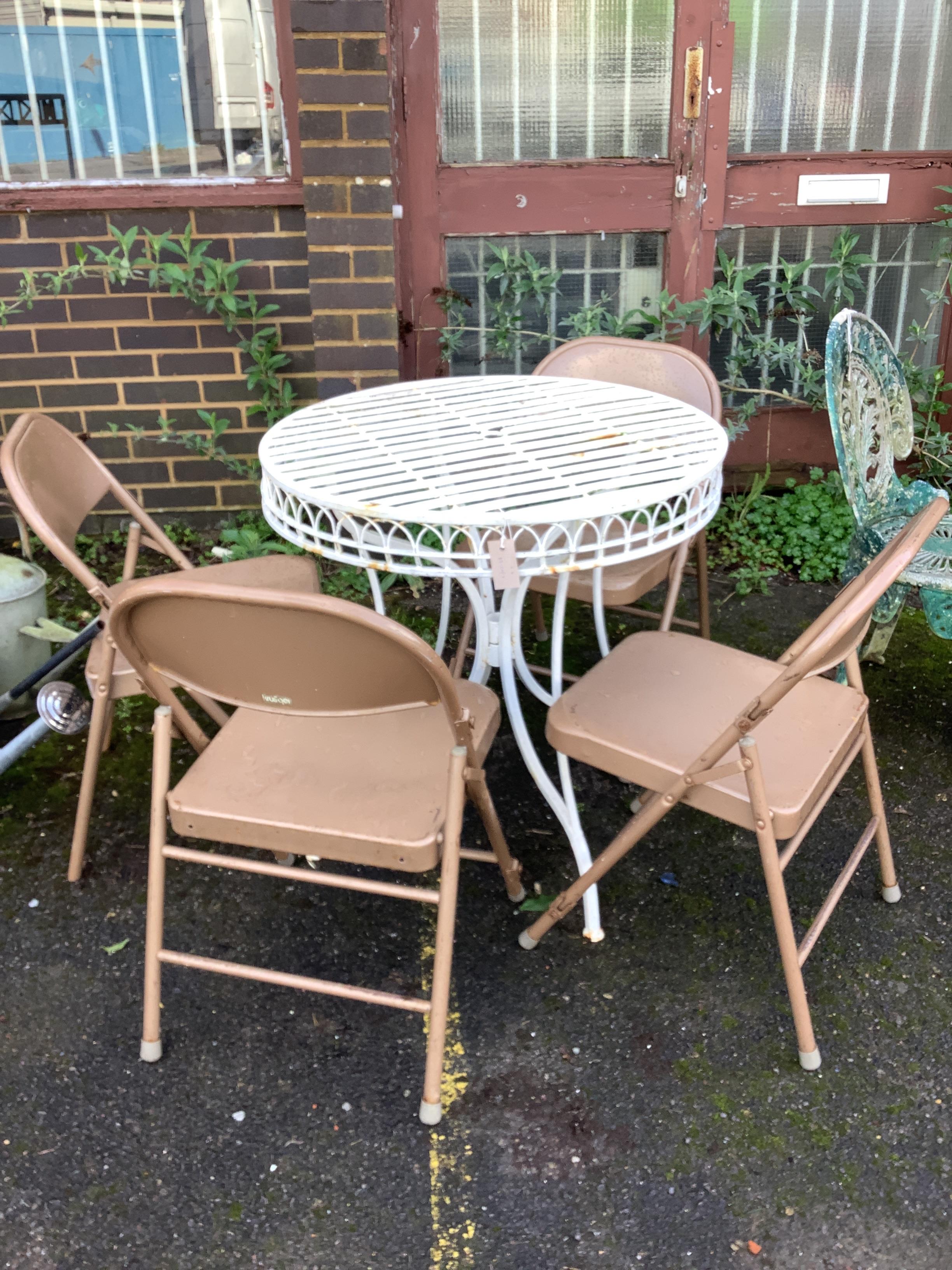A circular metal garden table, diameter 75cm, height 76cm, together with four metal folding chairs